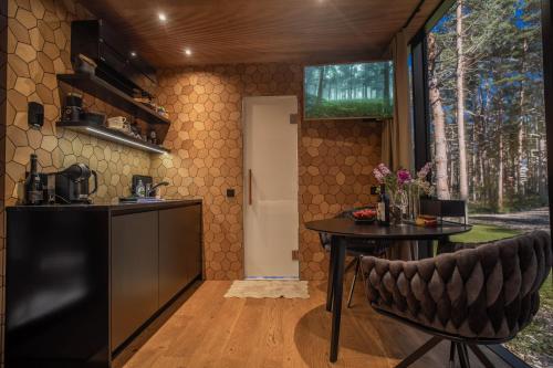 a kitchen with a counter and a table in a room at Tiny holiday complex in Kalana in Kalana