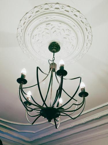 a large chandelier hanging from a ceiling at Hotel Lemonade in Gothenburg