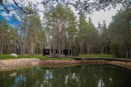 a pond in the middle of a forest at Tiny holiday complex in Kalana in Kalana