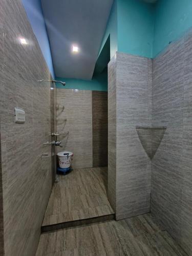 a bathroom with a shower and a toilet at Aira homestay in Guwahati