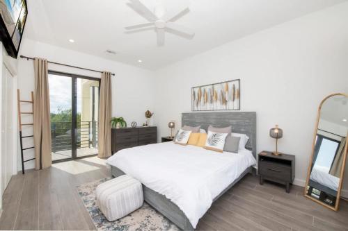 a bedroom with a bed and a large window at Allure #22 3BR Waterfront in Red Bay Estate