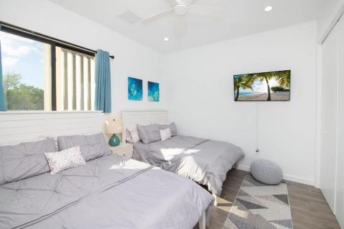 a bedroom with two beds and a window at Allure #22 3BR Waterfront in Red Bay Estate