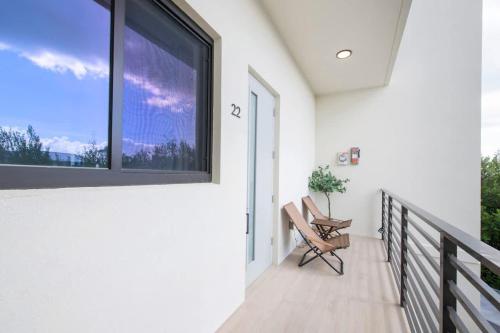a balcony with a window and a chair at Allure #22 3BR Waterfront in Red Bay Estate