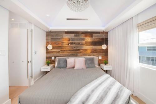 a bedroom with a large bed with two tables at Grape Tree Condo #10 in George Town