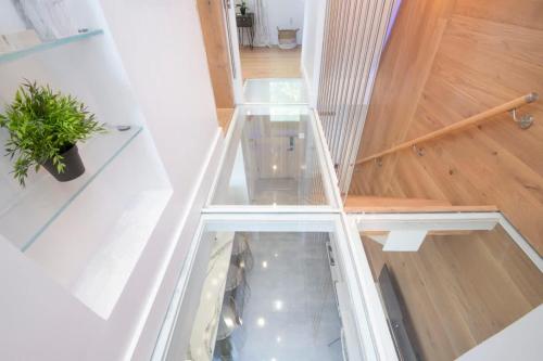 a glass floor in a room with a potted plant at Grape Tree Condo #10 in George Town