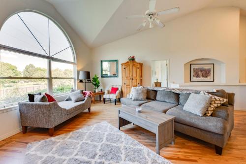 a living room with a couch and a table at Pet-Friendly Longmont Home with McIntosh Lake Access in Longmont