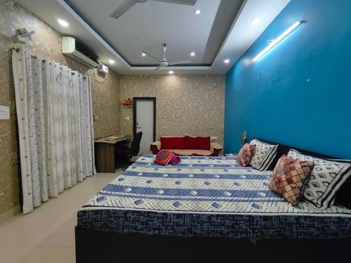 a bedroom with a bed and a blue wall at Aira homestay in Guwahati