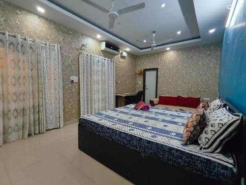 a bedroom with a bed with a blue comforter at Aira homestay in Guwahati