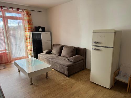 a living room with a couch and a refrigerator at L&B Lake view modern apartment in Lipno nad Vltavou