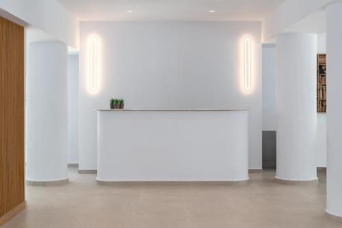 a large white table in a room with white walls at Rodos White in Rhodes Town