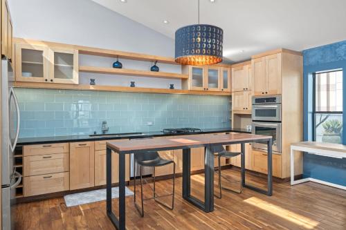 a kitchen with wooden cabinets and a table with stools at Tilden Hotel in San Francisco