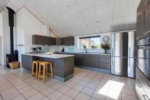 a large kitchen with gray cabinets and a counter at 2002-Romo-Juvrevej-51b in Toftum