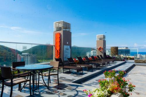 a row of tables and chairs on a roof at Reserva Del Mar Apartamentos in Gaira