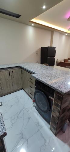 a kitchen with a counter with a washing machine at الغردقة شارع مترو in Hurghada