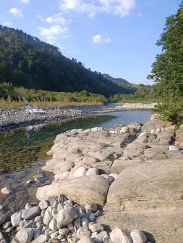 a river with rocks in the water at Holiday bungalows Pajkovir in Kolašin