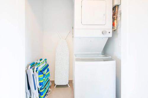 a refrigerator and a washer and dryer in a room at Summertime Suites #50 in West Bay