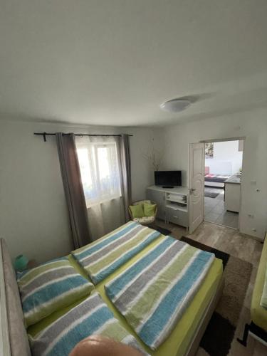 a bedroom with a bed and a desk and a window at Pol-Lak in Szőlősgyörök