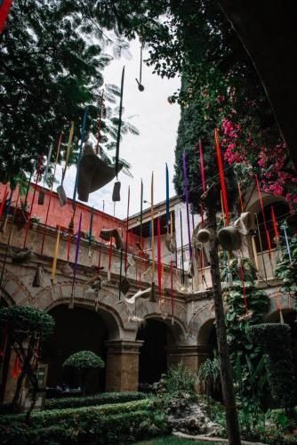 a building with many different colored flags on it at Quinta Real Oaxaca in Oaxaca City