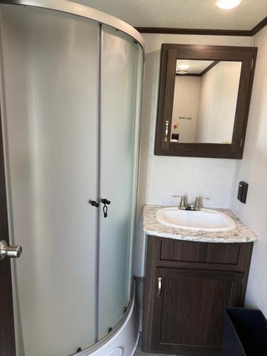a bathroom with a shower and a sink at Maitland Shires Resort in Port Maitland
