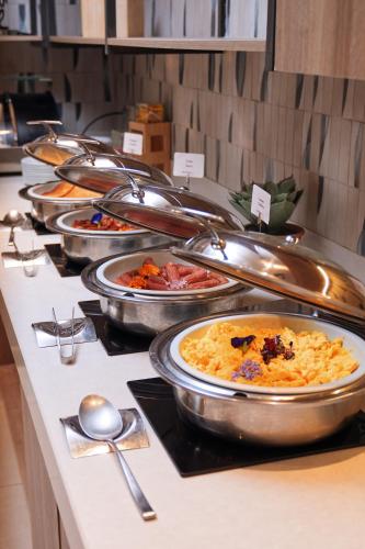 a buffet line with many different types of food at Residence Inn by Marriott Santiago de los Caballeros in Santiago de los Caballeros