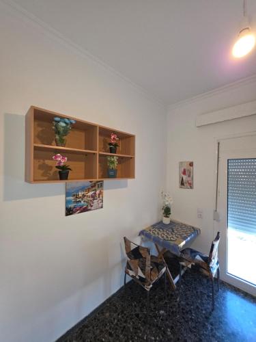 a room with a table and chairs and a window at Your refuge overlooking port 6A in Mesochórion
