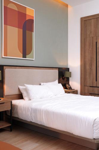 a bedroom with a large white bed and a desk at Residence Inn by Marriott Santiago de los Caballeros in Santiago de los Caballeros