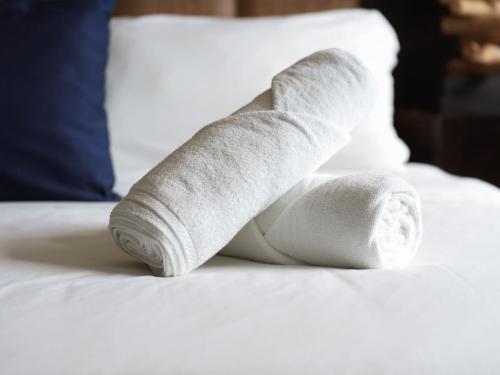 a pile of rolled up towels on a bed at Beach Apartment Nikki Steps From The Sea in El Chirú