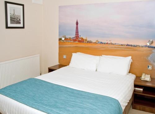 a bedroom with a bed with a picture of the eiffel tower at Best Western Carlton Hotel in Blackpool