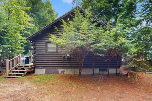 a log cabin with a porch and stairs to it at Lorax Lane in The Highlands
