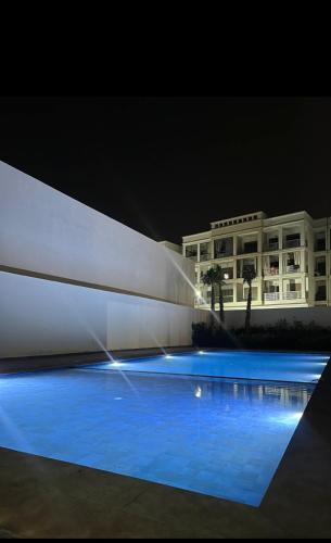 a water fountain in front of a building at night at Cosy&chill&piscine&3min à la plage in Bouznika