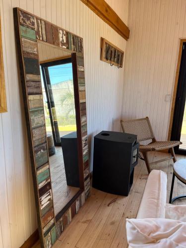 a mirror in the corner of a room with a tv at Redondo Beach frente al océano in Maldonado