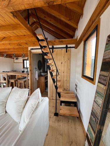 a living room with a staircase in a tiny house at Redondo Beach frente al océano in Maldonado
