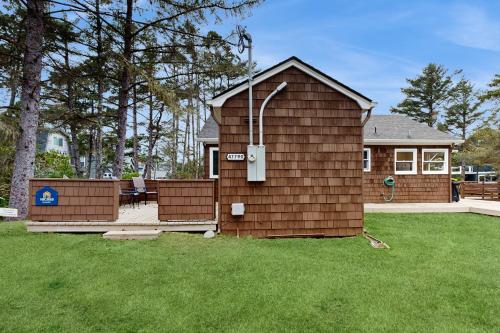 a small house with a deck in a yard at 2nd Tee at Neskowin Village in Neskowin