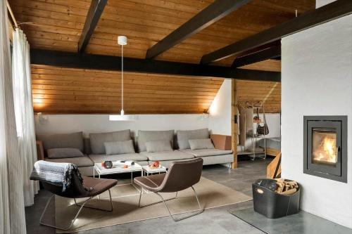 a living room with a couch and chairs and a fireplace at 530-Lemvig-Lokkevej-59-D in Lemvig