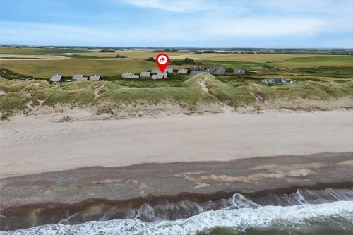 a stop sign on a beach next to the ocean at 530-Lemvig-Lokkevej-59-D in Lemvig