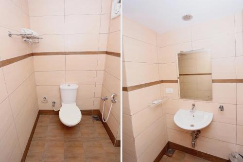 a bathroom with a toilet and a sink at Super Townhouse Dona Castle in Kollam