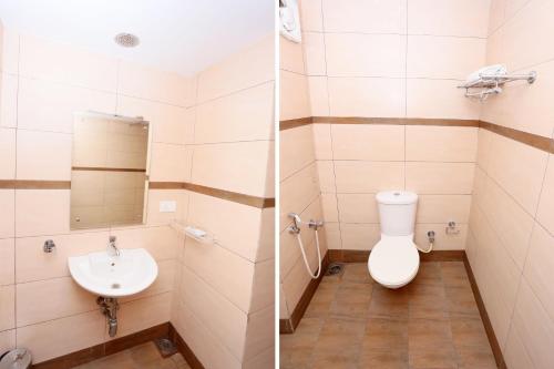 a bathroom with a toilet and a sink at Super Townhouse Dona Castle in Kollam