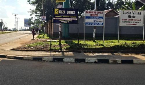 a group of signs on the side of a street at kuza Suites Mbale in Mbale