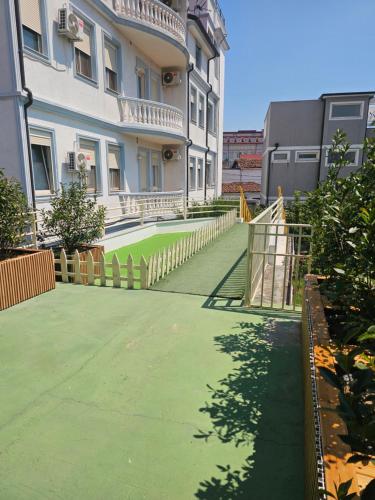 a building with a green lawn in front of it at Eagle’s Nest in Shkodër