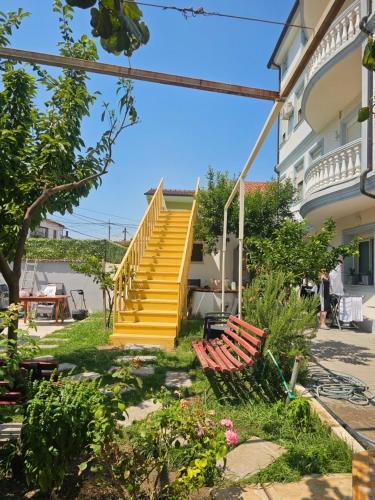a yellow staircase in a building with two benches at Eagle’s Nest in Shkodër