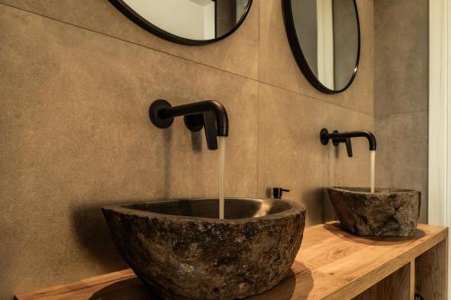a bathroom with a large stone sink and a mirror at The View Premium Villas in Perdika