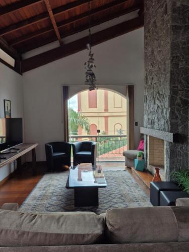 a living room with a couch and a fireplace at Apartamento ao lado do Shopping Lamérica in Bento Gonçalves