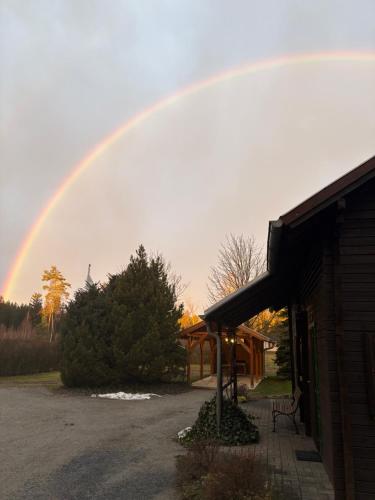 a rainbow in the sky over a house at Forsthaus Luchsenburg in Ohorn