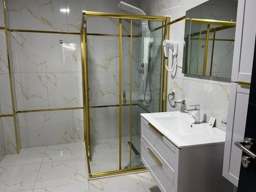 a bathroom with a shower and a sink at Golden Hill Palace in Novi Pazar