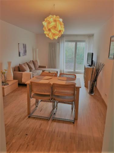a living room with a table and a couch at Apartments Im Sportpark in Weil am Rhein