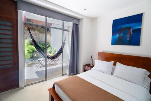 a bedroom with a bed and a large window at Suites House in Cali