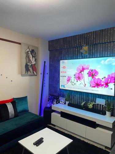 a living room with a large flat screen tv at Olivia homes in Nairobi