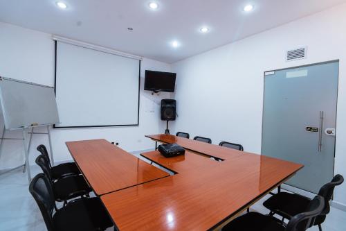 a conference room with a wooden table and chairs at Suites House in Cali