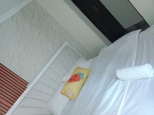 a white bed with a pillow on it at Stylish 1BR Escape in Thika Sec 2 in Thika