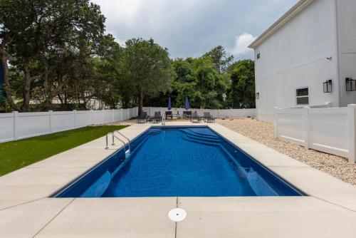 a swimming pool in the backyard of a house at Dog Friendly Hot Tub Walk to Beach in Southern Shores